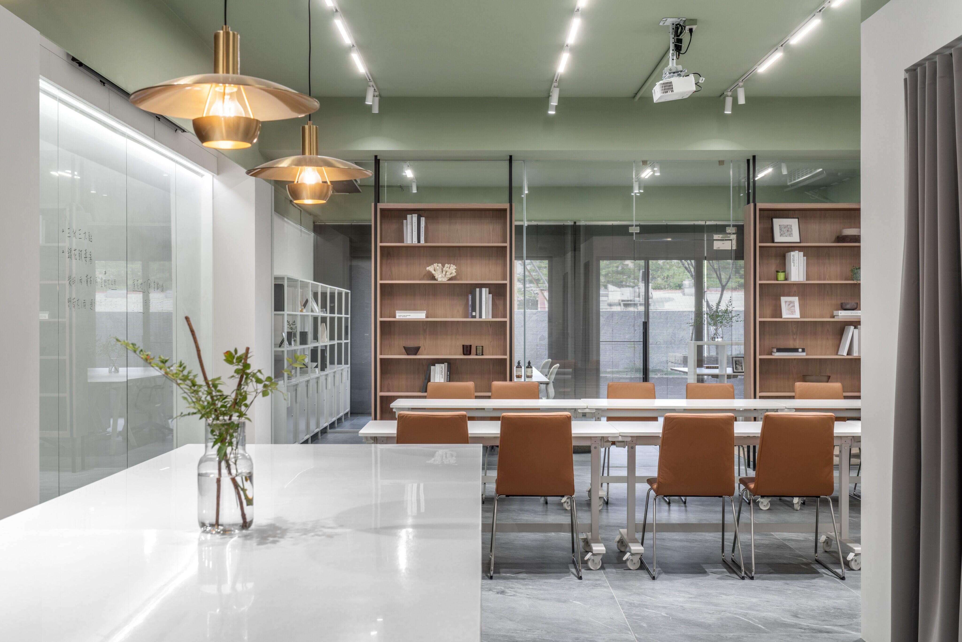走進至和中醫辦公室，陽光灑落、綠意盎然。苔癬綠天花與漂浮文字牆延續自然氣息，開放書櫃劃分會議與辦公區，是值得參考的辦公室設計案例。